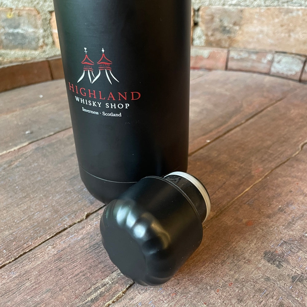 Black water bootle with 'Highland Whisky Shop' branding on a wooden surface