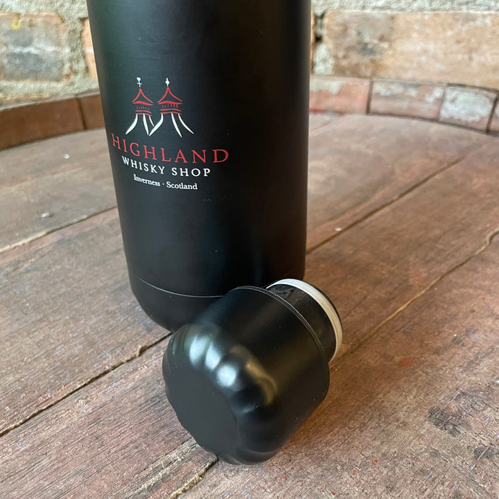 Black water bootle with 'Highland Whisky Shop' branding on a wooden surface
