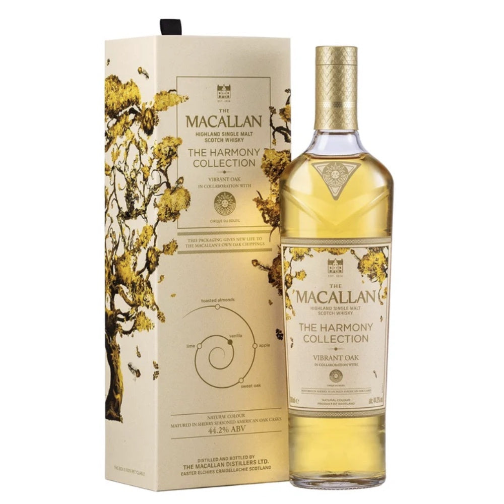 A bottle of The Macallan The Harmony Collection Vibrant Oak Speyside single malt Scotch whisky next to its matching cream-colored packaging box, both decorated with gold and black tree branch illustrations, on a solid white background.